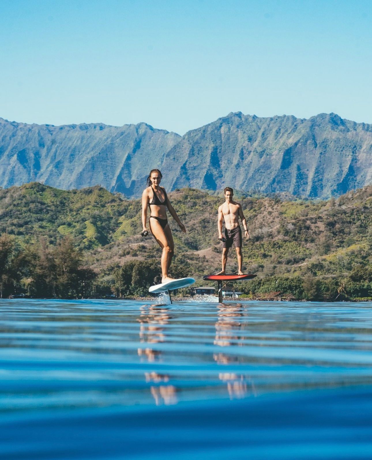 Warm-water eFoil carve with islands in the background
