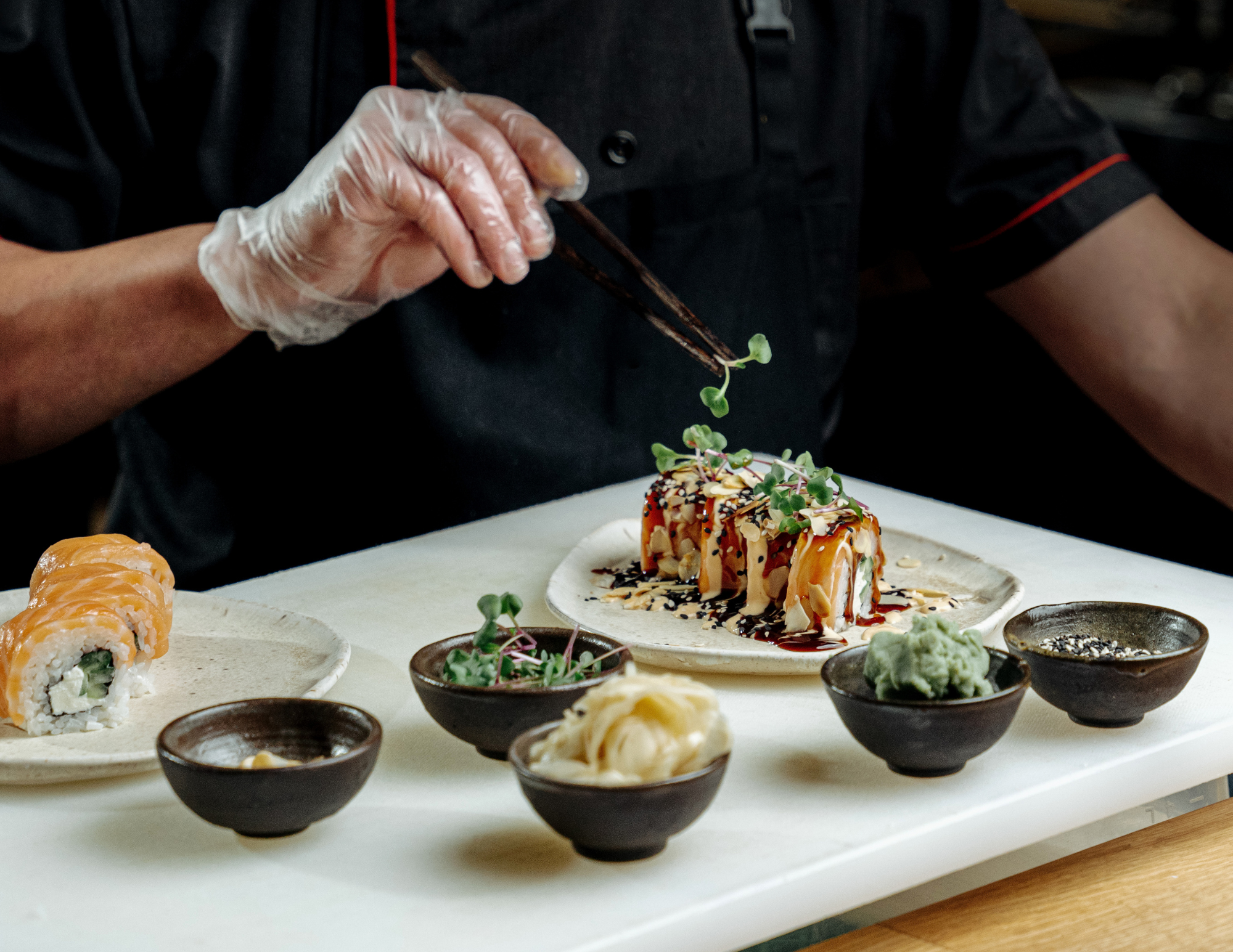 Chef preparing sushi on board
